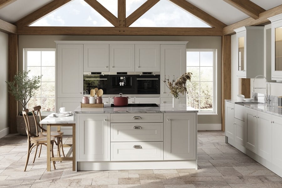 A photo of a beautiful marble and stone-coloured kitchen with vaulted ceilings