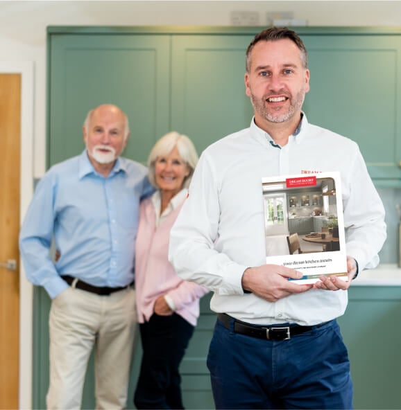 a Dream Doors expert holding a brochure and smiling for the camera