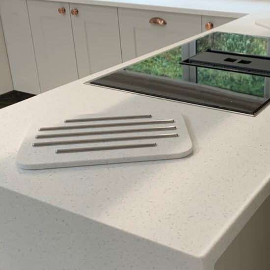 a light quartz waterfall style worktop